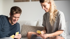 Couple playing cards in bed