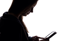Silhouette of woman using tablet