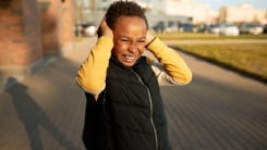 little boy with hands over ears