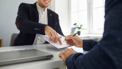 two businesspeople with a contract
