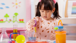 young girl doing science experiment