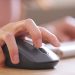 A person with a raised finger about to press the middle mouse button